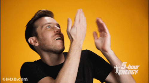 A Man Is Clapping In Front Of A 5 Hour Energy Ad GIF