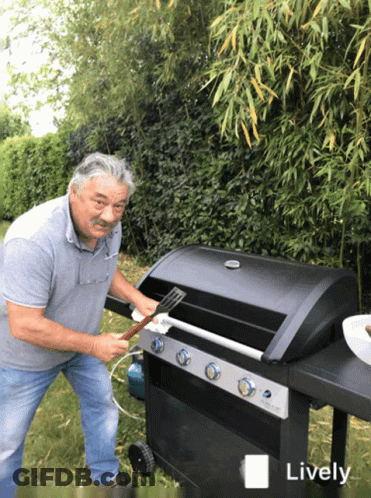A Man Is Cleaning A Grill With A Spatula And The Word Lively Is Visible GIF