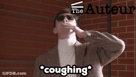 A Man Is Coughing In Front Of A Brick Wall With The Authors Logo GIF