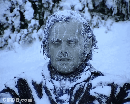 A Man Is Covered In Snow And Ice And Has The Word Nightmare On His Shirt GIF