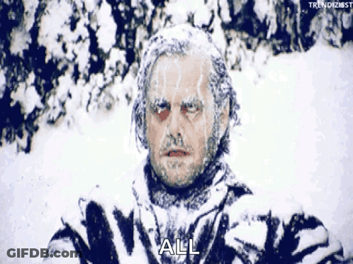 A Man Is Covered In Snow And The Word All Is Visible On His Face . GIF