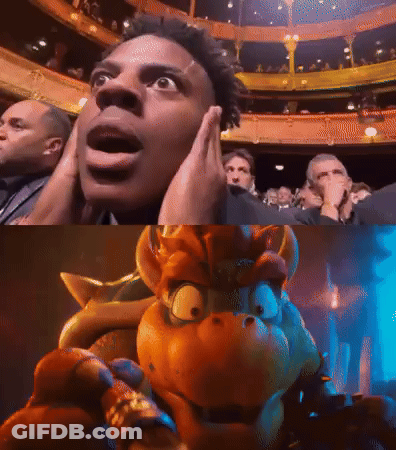 A Man Is Covering His Ears In Front Of A Crowd And A Picture Of A Cartoon Character GIF