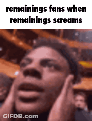 A Man Is Covering His Ears With His Hands While Screaming In Front Of A Crowd . GIF