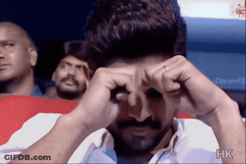 A Man Is Covering His Eyes With His Hands And The Letters Hk Are On The Bottom Right GIF