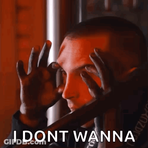 A Man Is Covering His Eyes With His Hands And The Words I Dont Wanna Are Below Him . GIF