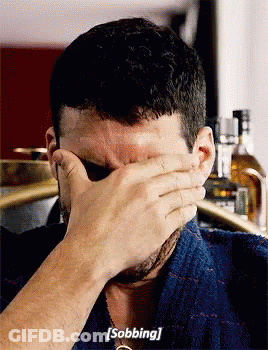 A Man Is Covering His Face With His Hand And Saying Sobbing GIF