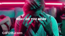 A Man Is Covering His Face With His Hands And The Words What Do You Mean Are Written Above Him . GIF