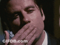 Man Covering Mouth Talking On Phone GIF