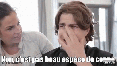 A Man Is Covering His Nose With His Hand While A Woman Looks On In A Salon . GIF