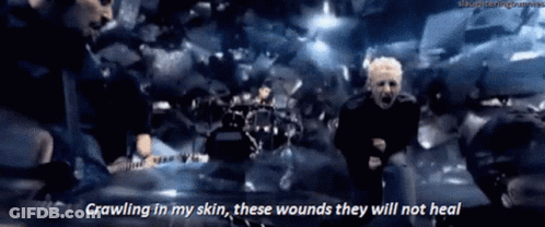 A Man Is Crawling In His Skin While Playing A Guitar And Singing . GIF