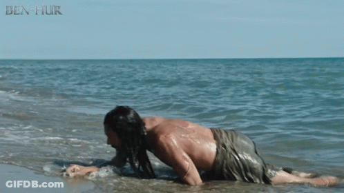 A Man Is Crawling In The Water With Ben Hur Written In The Corner GIF