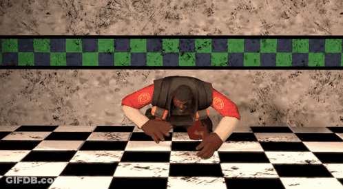 A Man Is Crawling On A Checkered Floor In Front Of A Wall GIF