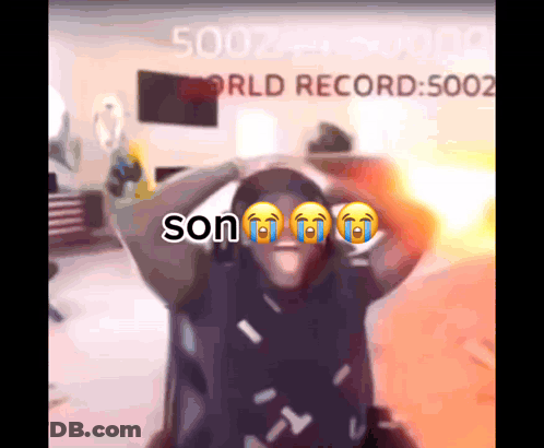 A Man Is Crying In Front Of A Screen That Says Son GIF