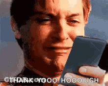 A Man Is Crying While Holding A Cell Phone And Says `` Thank You , Hooo Ugh '' . GIF