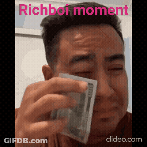 A Man Is Crying While Holding A Stack Of Money With The Words Richboi Moment Written Above Him GIF