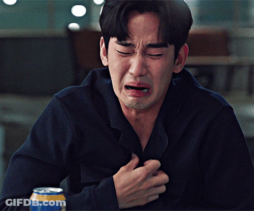 A Man Is Crying While Holding His Chest And A Can Of Beer Is In Front Of Him GIF