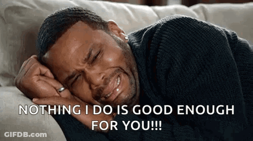 A Man Is Crying While Laying On A Couch With The Words `` Nothing I Do Is Good Enough For You '' GIF
