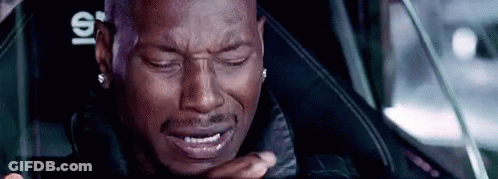 A Man Is Crying While Sitting In A Car Seat . GIF
