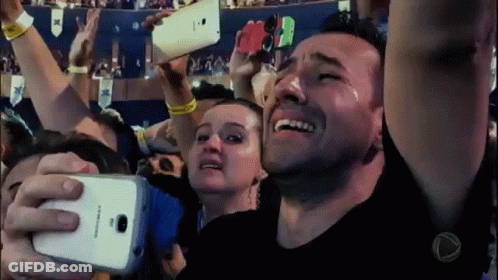 A Man Is Crying While Taking A Picture Of Himself With A Samsung Phone GIF