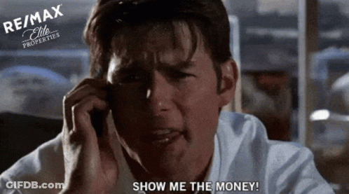 A Man Is Crying While Talking On A Cell Phone With Re / Max Properties In The Background GIF