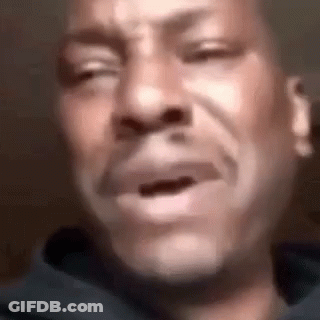 A Man Is Crying With His Eyes Closed And His Mouth Open . GIF
