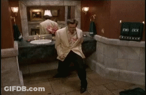 A Man Is Dancing In A Bathroom In Front Of A Sink . GIF