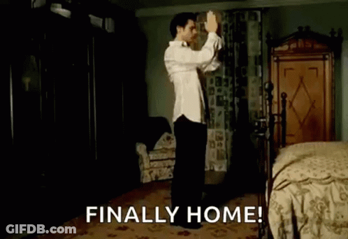 A Man Is Dancing In A Bedroom With The Words `` Finally Home '' Written Above Him . GIF