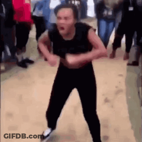 A Man Is Dancing In A Crowd Of People . GIF