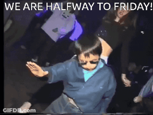 A Man Is Dancing In A Dark Room With The Words We Are Halfway To Friday GIF