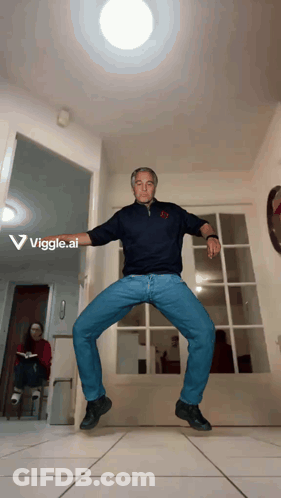 A Man Is Dancing In A Hallway With The Words Viggle.ai Visible Behind Him GIF