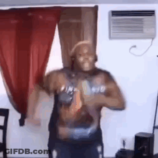 A Man Is Dancing In A Living Room In Front Of A Window And Air Conditioner . GIF
