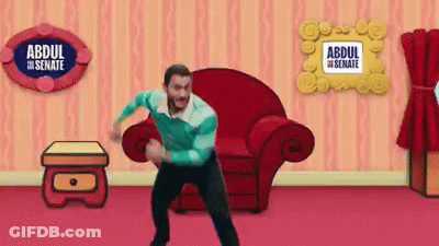 A Man Is Dancing In A Living Room With A Sign That Says Abdul The Senate On It GIF