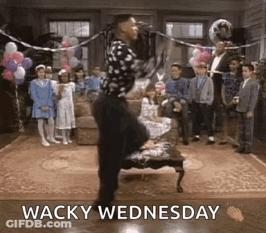 A Man Is Dancing In A Living Room With Balloons And The Words Wacky Wednesday Below Him . GIF
