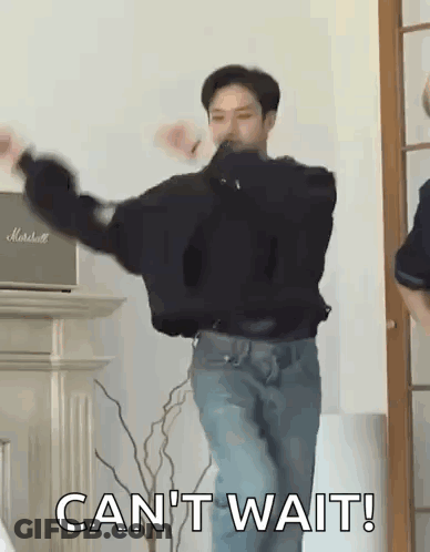 A Man Is Dancing In A Living Room With The Words `` Can 'T Wait '' Written On The Bottom . GIF
