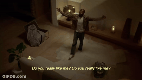 A Man Is Dancing In A Living Room With The Words Do You Really Like Me Behind Him GIF