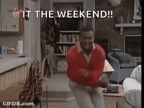 A Man Is Dancing In A Living Room With The Words `` It The Weekend '' Written On The Screen . GIF