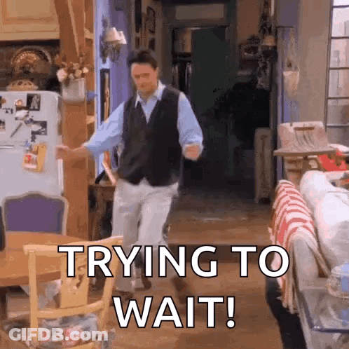 A Man Is Dancing In A Living Room With The Words `` Trying To Wait '' Written On The Bottom . GIF