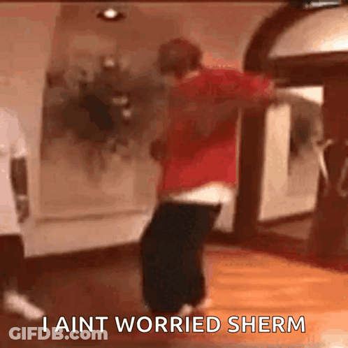 A Man Is Dancing In A Room With The Words I Ain T Worried Sherm Written On The Bottom GIF