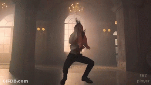 A Man Is Dancing In A Room With The Words Skz Player Visible GIF