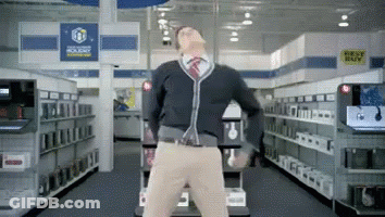 A Man Is Dancing In A Store With A Sign That Says Best Buy In The Background GIF