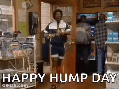 A Man Is Dancing In A Store With The Words `` Happy Hump Day '' Written On The Screen . GIF