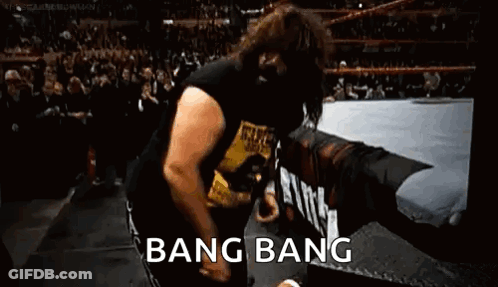 A Man Is Dancing In A Wrestling Ring With The Words `` Bang Bang '' Written On The Bottom . GIF