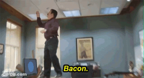A Man Is Dancing In An Office With The Words Bacon Written On The Bottom GIF