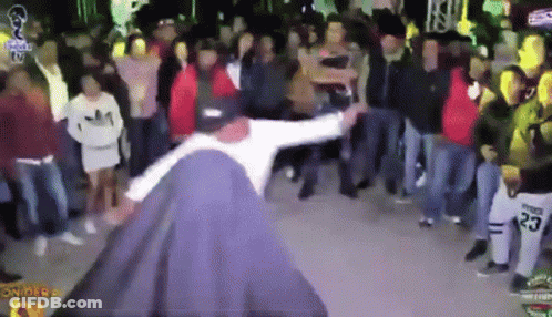 A Man Is Dancing In Front Of A Crowd With The Number 23 On His Shirt GIF
