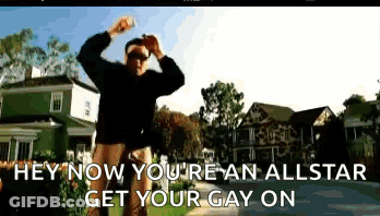 A Man Is Dancing In Front Of A Green House With The Words Hey Now You 'Re An Allstar Get Your Gay On Written Below Him GIF
