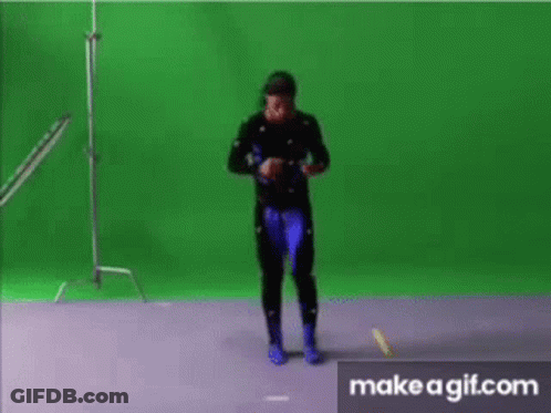 A Man Is Dancing In Front Of A Green Screen .. GIF