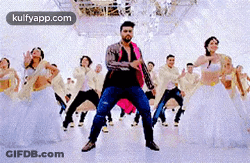A Man Is Dancing In Front Of A Group Of Dancers In A Dance Studio . GIF
