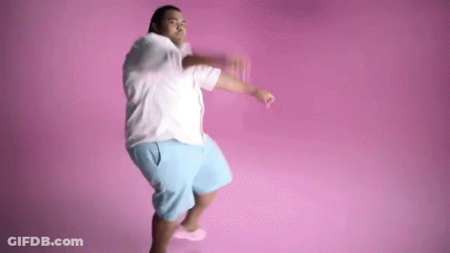 A Man Is Dancing In Front Of A Pink Background . GIF