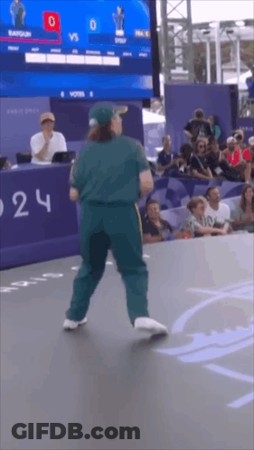 A Man Is Dancing In Front Of A Scoreboard That Says 0 Vs 0 GIF