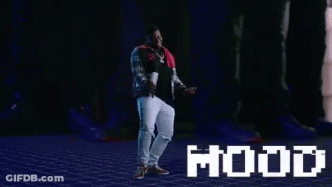 A Man Is Dancing In Front Of A Screen That Says Mood GIF